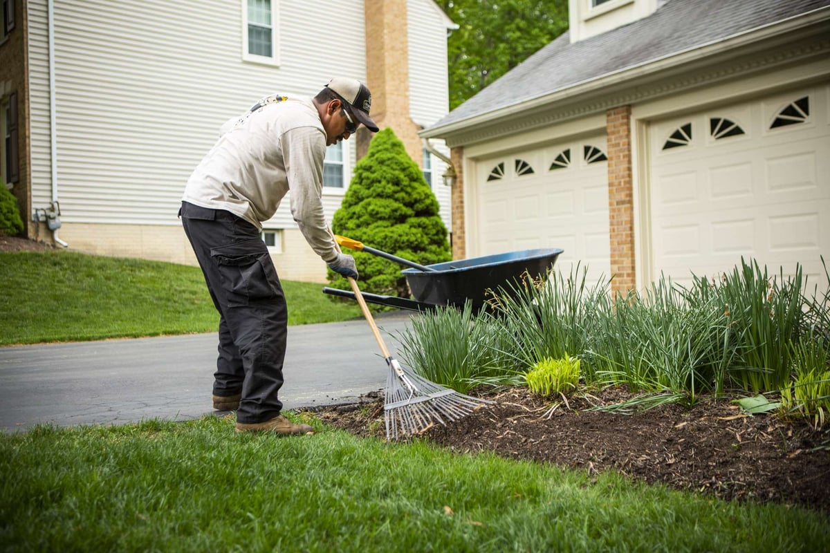 Lawn maintenance technician mulching lawn