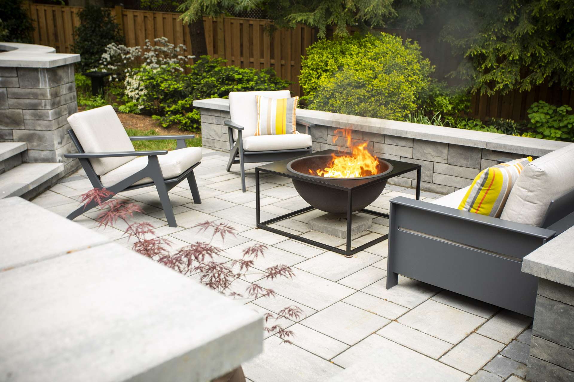 patio and sitting wall with firepit and patio furniture