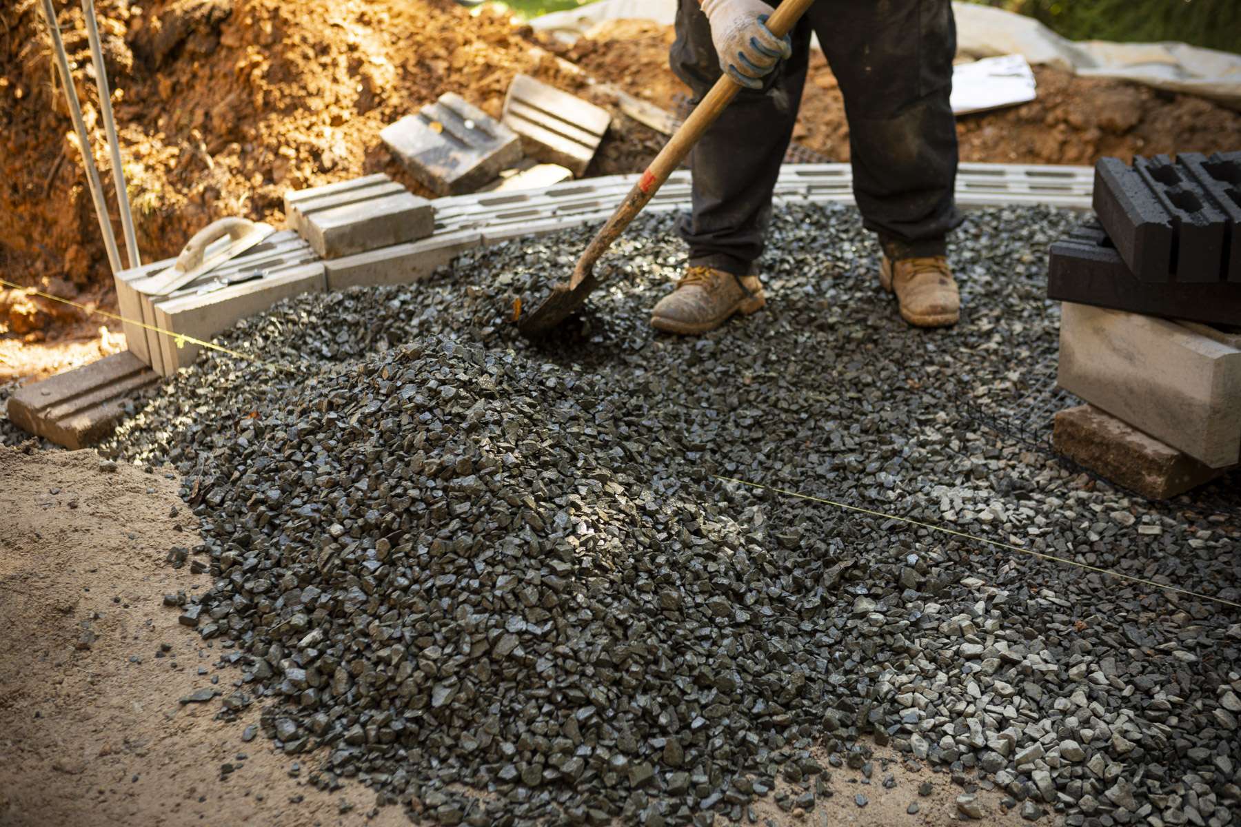 landscapers installing a patio and retaining wall in an arlington virginia backyard