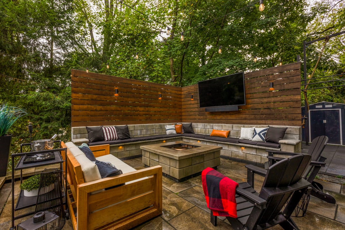 outdoor living area with patio firepit sitting wall and outdoor television